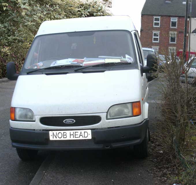A nob-head parking inconsiderately on a corner and on the pavement